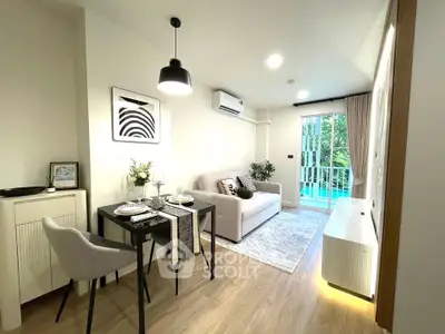 Modern living room with stylish decor and pool view, featuring cozy seating and dining area.