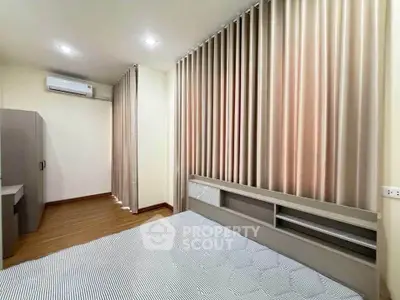 Spacious bedroom with modern design and elegant curtains