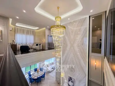 Luxurious two-story living room with elegant chandelier and modern decor