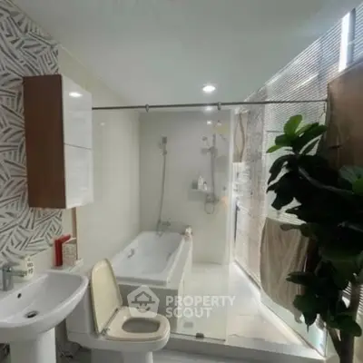 Modern bathroom with bathtub and stylish decor in a contemporary home.