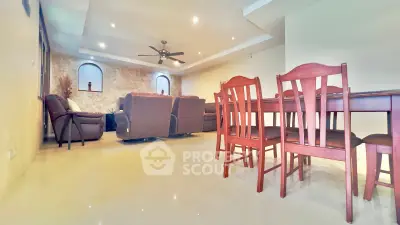 Spacious living room with elegant dining area and cozy seating, perfect for family gatherings.