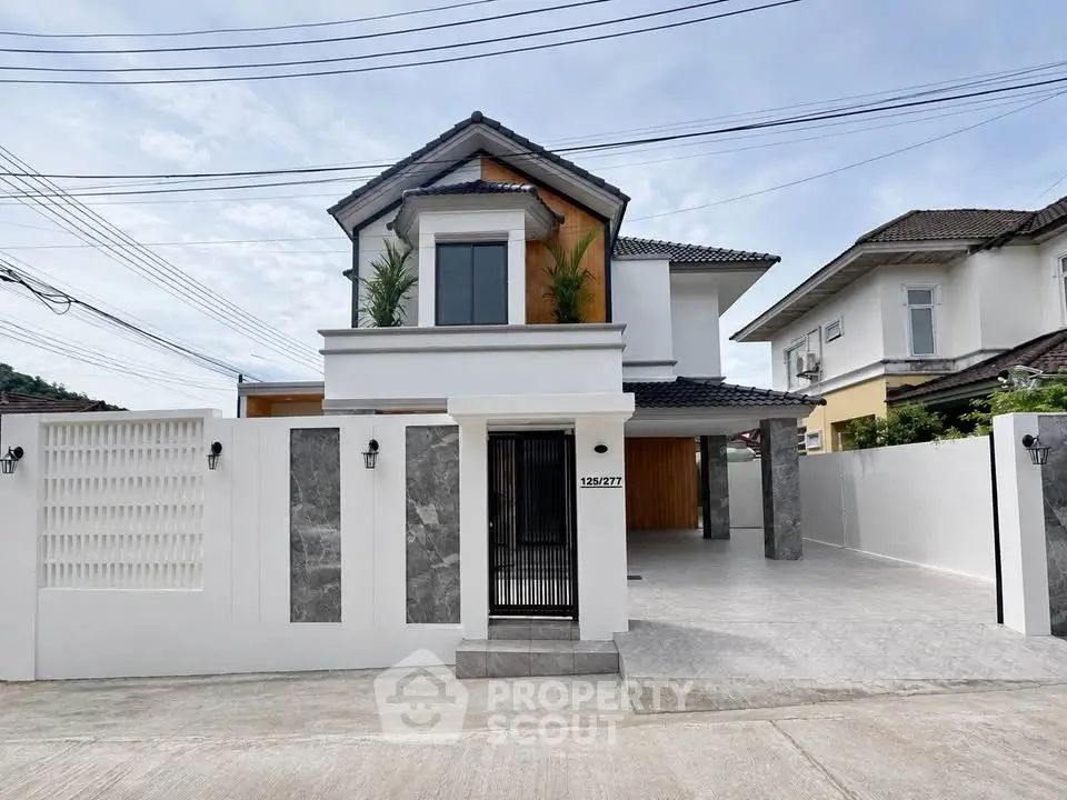 Modern two-story house with spacious driveway and elegant facade in a serene neighborhood.
