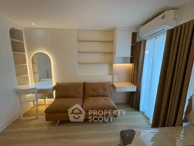 Modern living room with stylish sofa, built-in shelves, and elegant lighting
