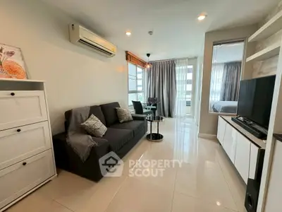 Modern living room with sleek furniture and natural light in a stylish apartment.