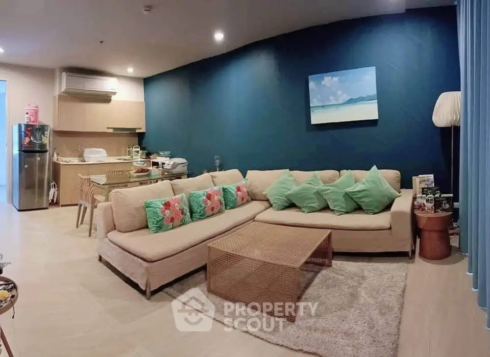 Spacious living room with modern decor and open kitchen layout