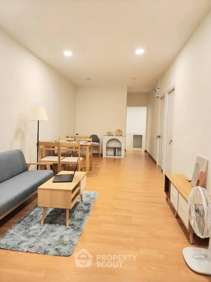 Modern living room with wooden flooring and minimalist furniture
