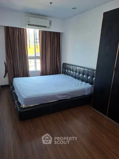 Spacious bedroom with modern design and large window for natural light