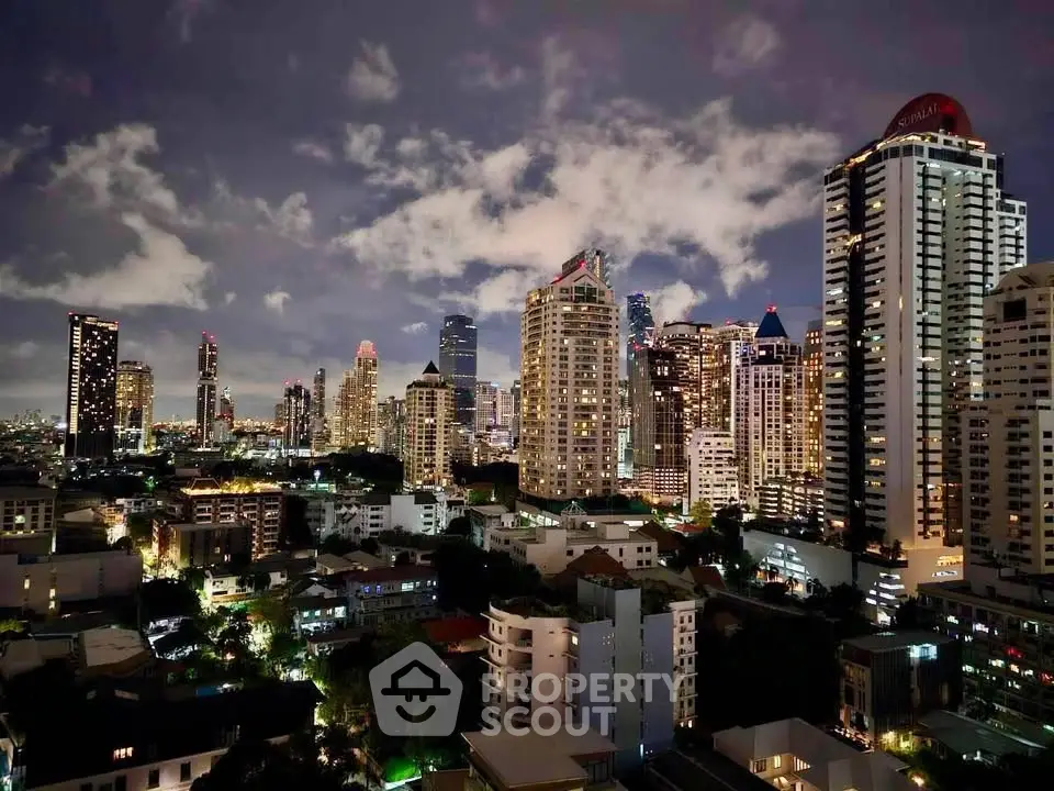 Stunning night view of a vibrant city skyline with illuminated skyscrapers and urban landscape.