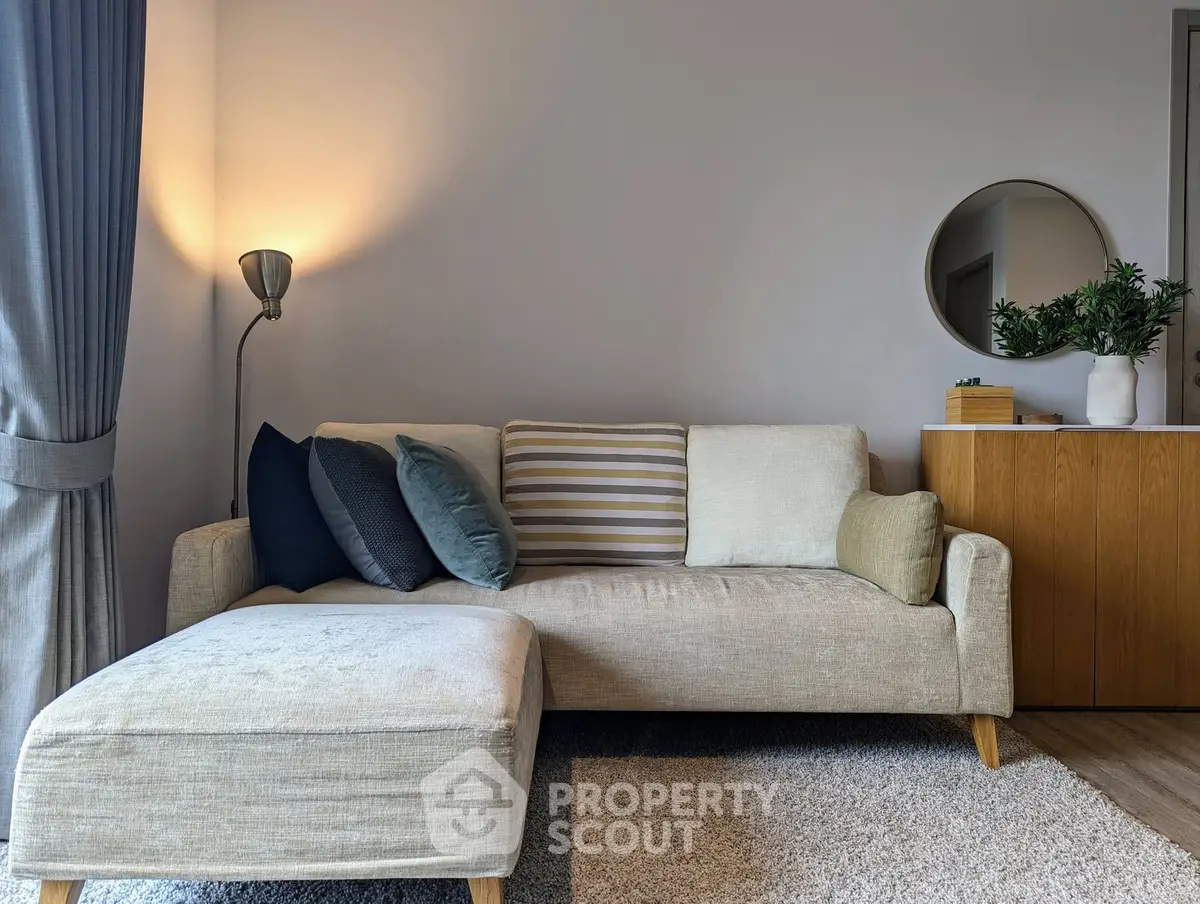 Cozy living room with stylish sofa, modern decor, and warm lighting for a welcoming ambiance.