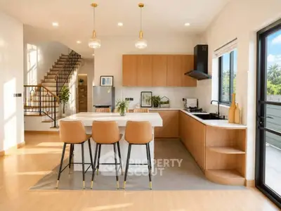 Modern kitchen with open layout, stylish island, and elegant lighting in a bright, spacious home.