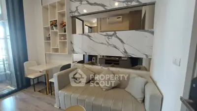 Modern living room with stylish marble accents and cozy seating area