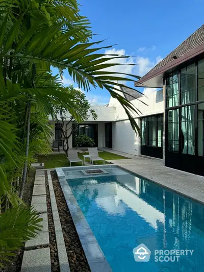 Luxurious modern villa with private pool and lush garden, perfect for relaxation and entertaining.