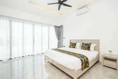 Spacious modern bedroom with large windows and elegant decor