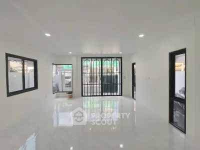 Spacious modern living room with large windows and marble flooring