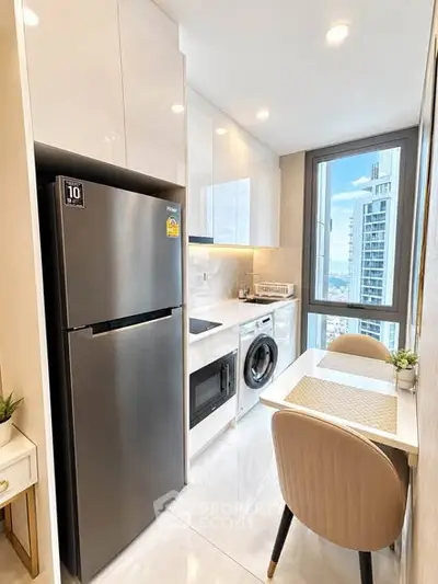 Modern kitchen with sleek appliances and city view from window