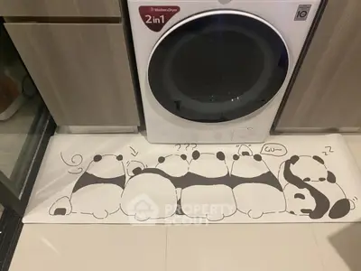 Modern laundry area with washer-dryer combo and cute panda-themed floor mat.