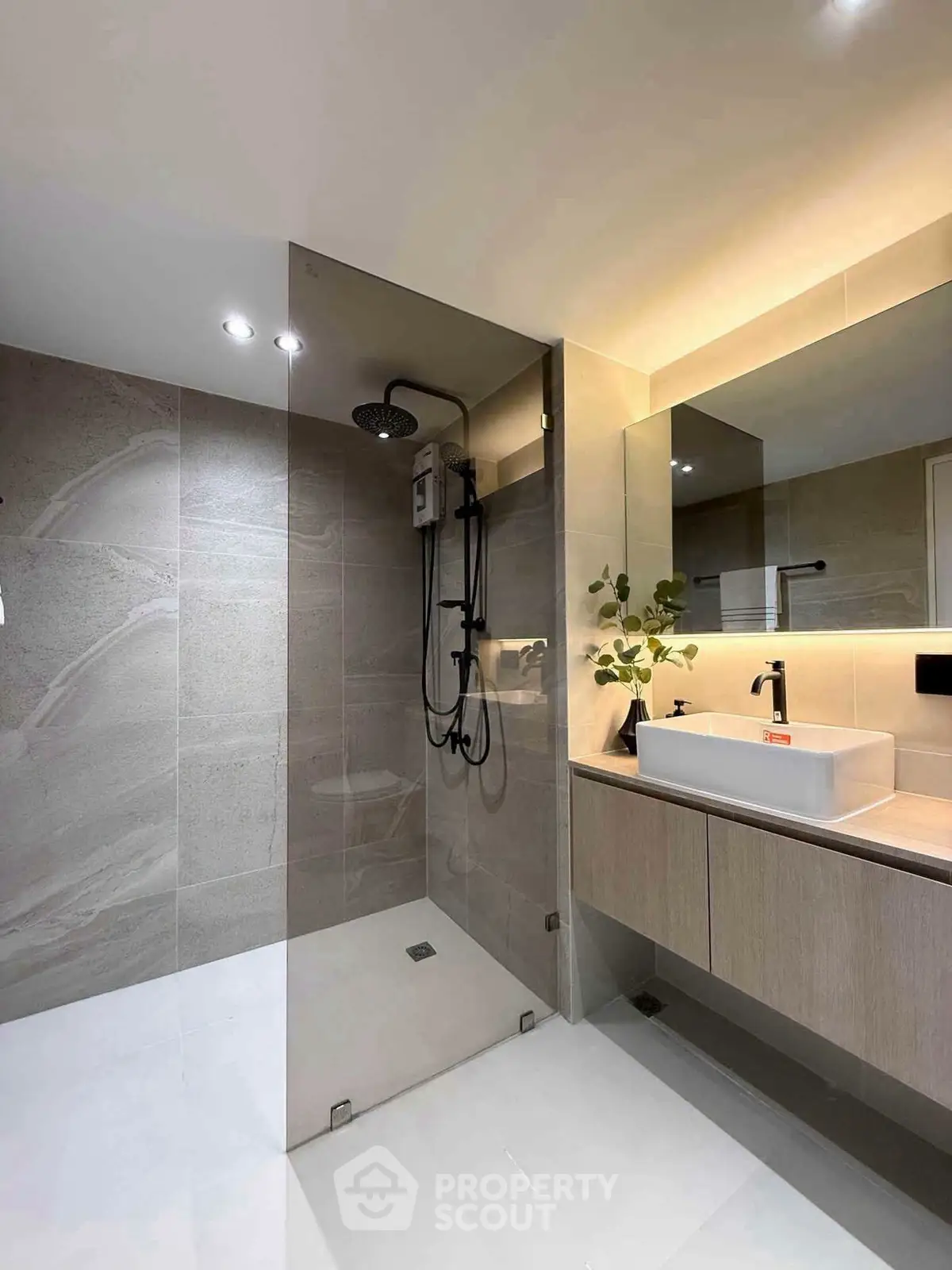 Modern bathroom with sleek shower and elegant vanity in contemporary design.