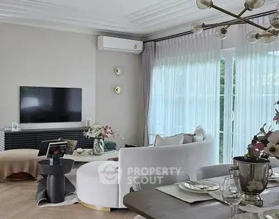 Luxurious living room with modern decor and large windows for natural light.