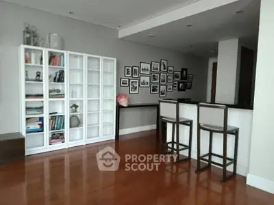 Spacious living room with elegant wooden flooring and stylish decor