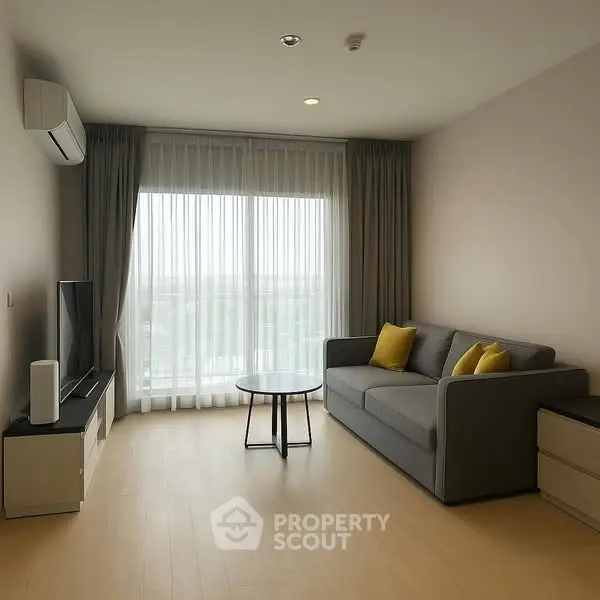 Modern living room with large window, gray sofa, and sleek TV setup