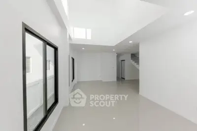 Spacious modern living room with large windows and minimalist design