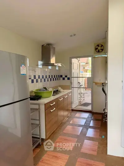 Charming kitchen with modern appliances and open layout leading to outdoor space.