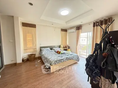 Spacious bedroom with balcony access and modern decor