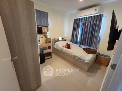 Cozy bedroom with modern furnishings and ample natural light, perfect for relaxation and comfort.