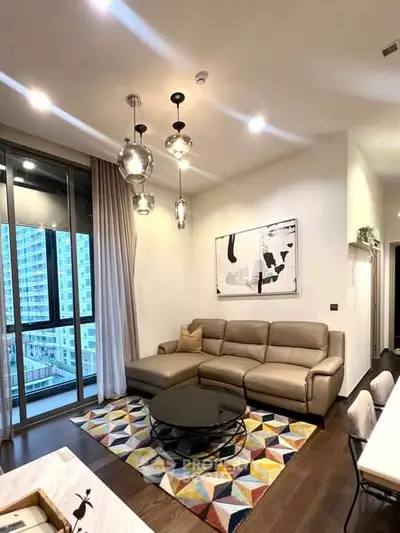 Modern living room with stylish decor and city view balcony access.