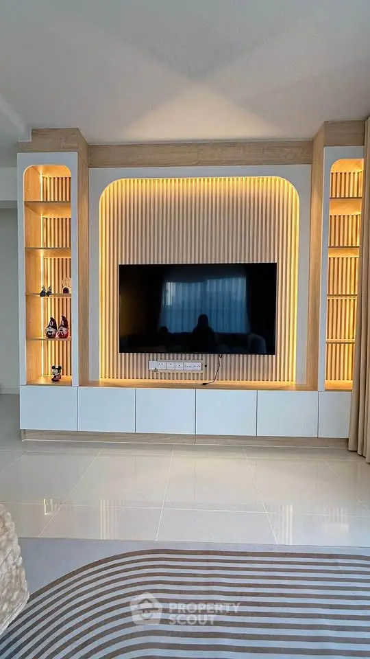 Modern living room with stylish TV wall unit and ambient lighting