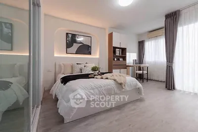 Modern bedroom with stylish decor, large windows, and elegant furnishings in a cozy apartment.