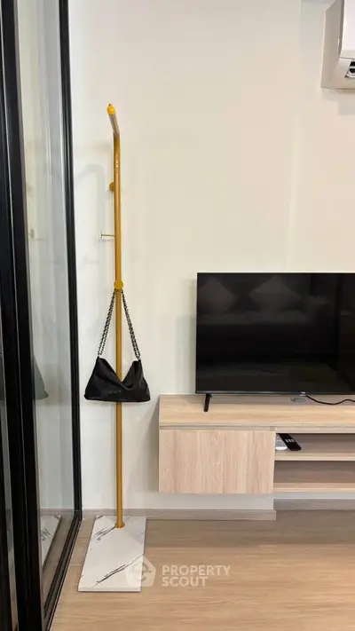 Modern living room with sleek TV stand and stylish coat rack