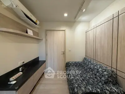 Cozy living room with modern decor and wall-mounted air conditioning unit.