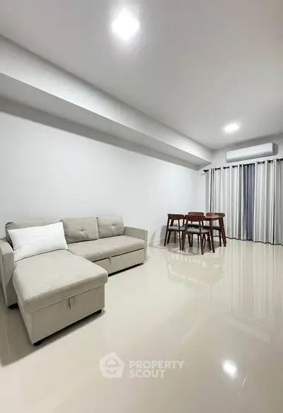 Spacious modern living room with sleek furniture and bright lighting