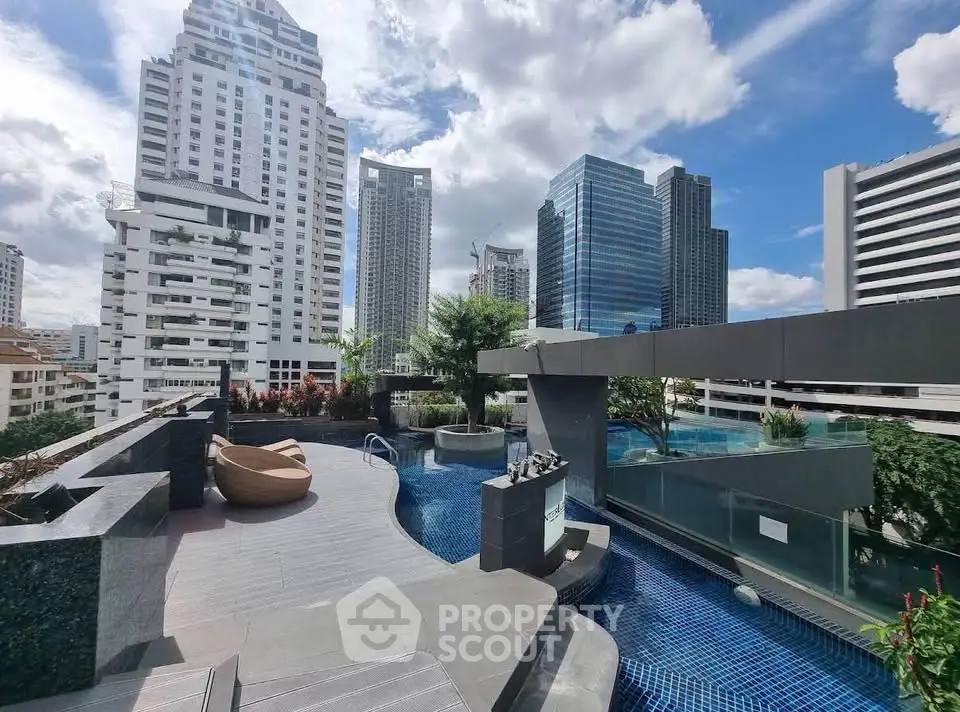 Luxurious rooftop pool with stunning city skyline views in a modern high-rise building.