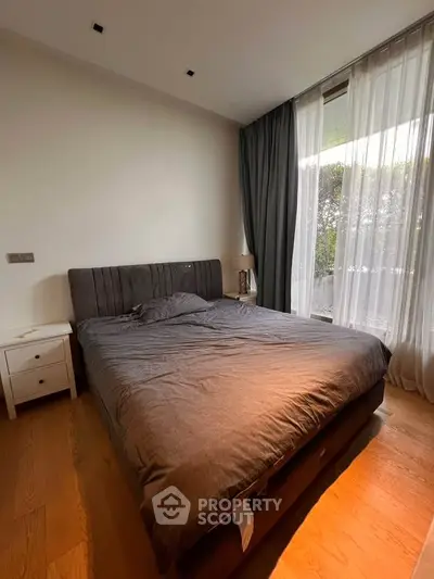 Cozy bedroom with large window and modern decor