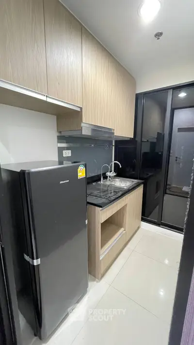 Modern compact kitchen with sleek appliances and stylish cabinetry