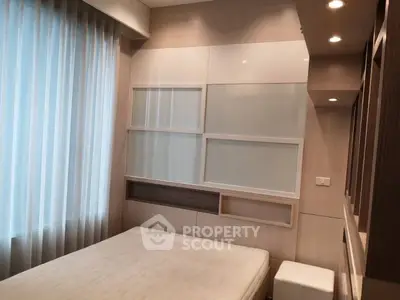 Modern bedroom with stylish wall paneling and natural light