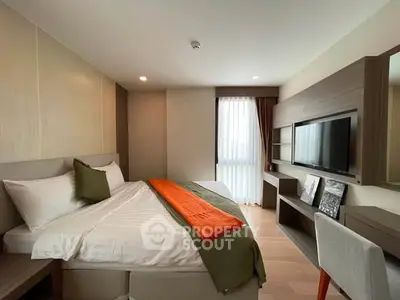 Modern bedroom with stylish decor, featuring a cozy bed, wall-mounted TV, and elegant furnishings.