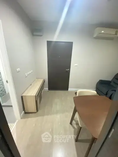 Cozy living room with modern furniture and air conditioning in a compact apartment.