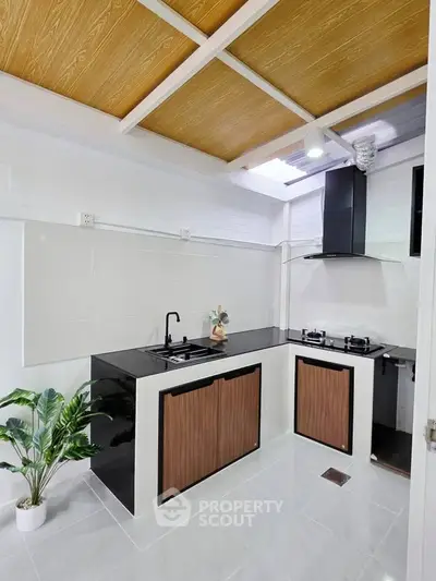 Modern kitchen with sleek black countertops and gas stove