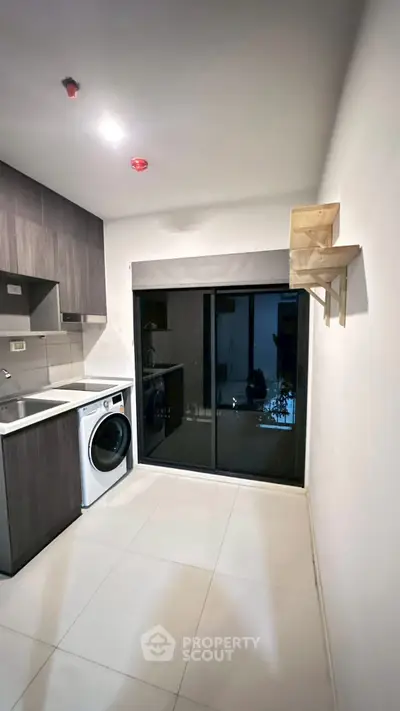 Modern kitchen with sleek cabinetry and built-in washing machine