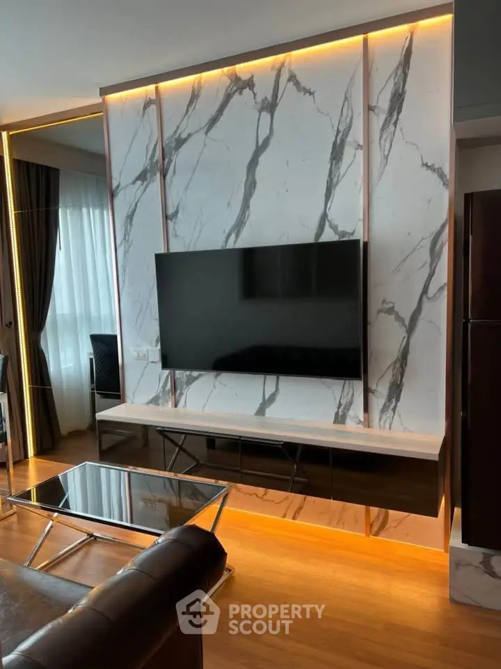 Luxurious living room with marble accent wall and modern TV setup