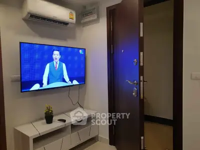 Modern interior with wall-mounted TV and air conditioning in a cozy living space.