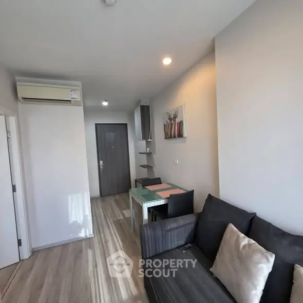 Modern living room with sleek design and cozy seating area in a stylish apartment.