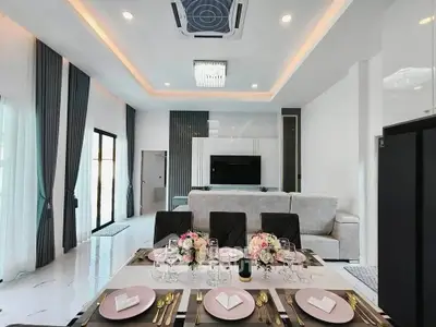 Luxurious open-plan living and dining area with elegant decor and modern furnishings.