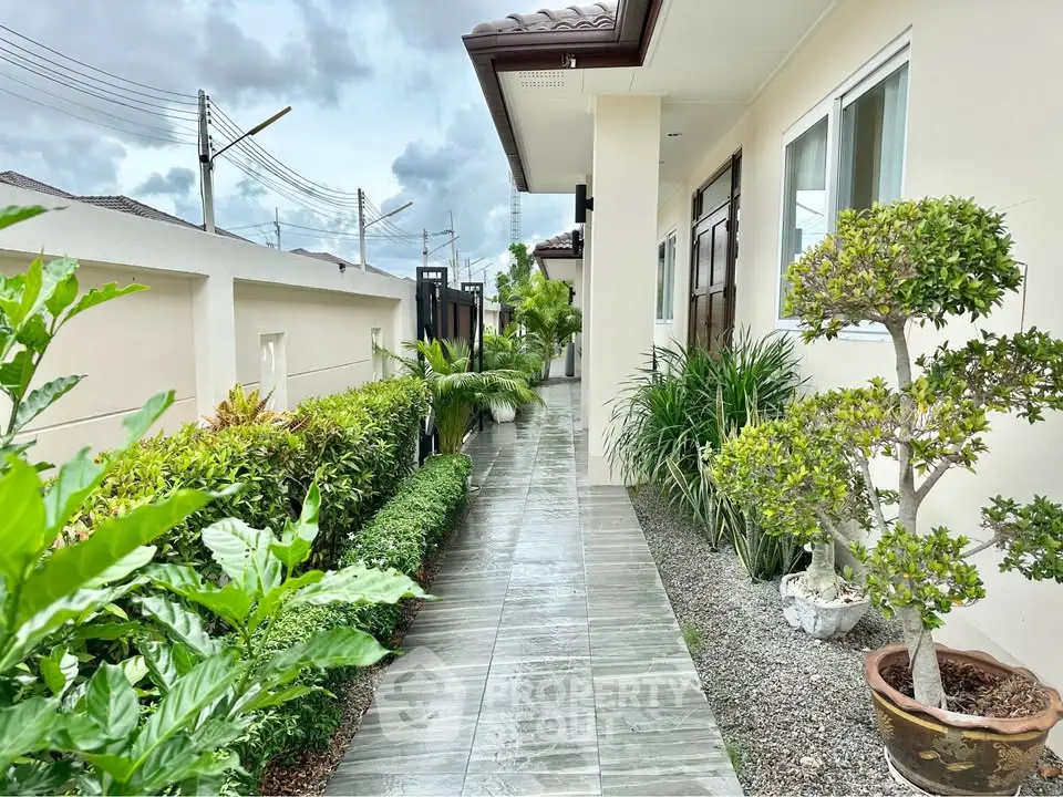 Charming exterior walkway with lush greenery and modern design