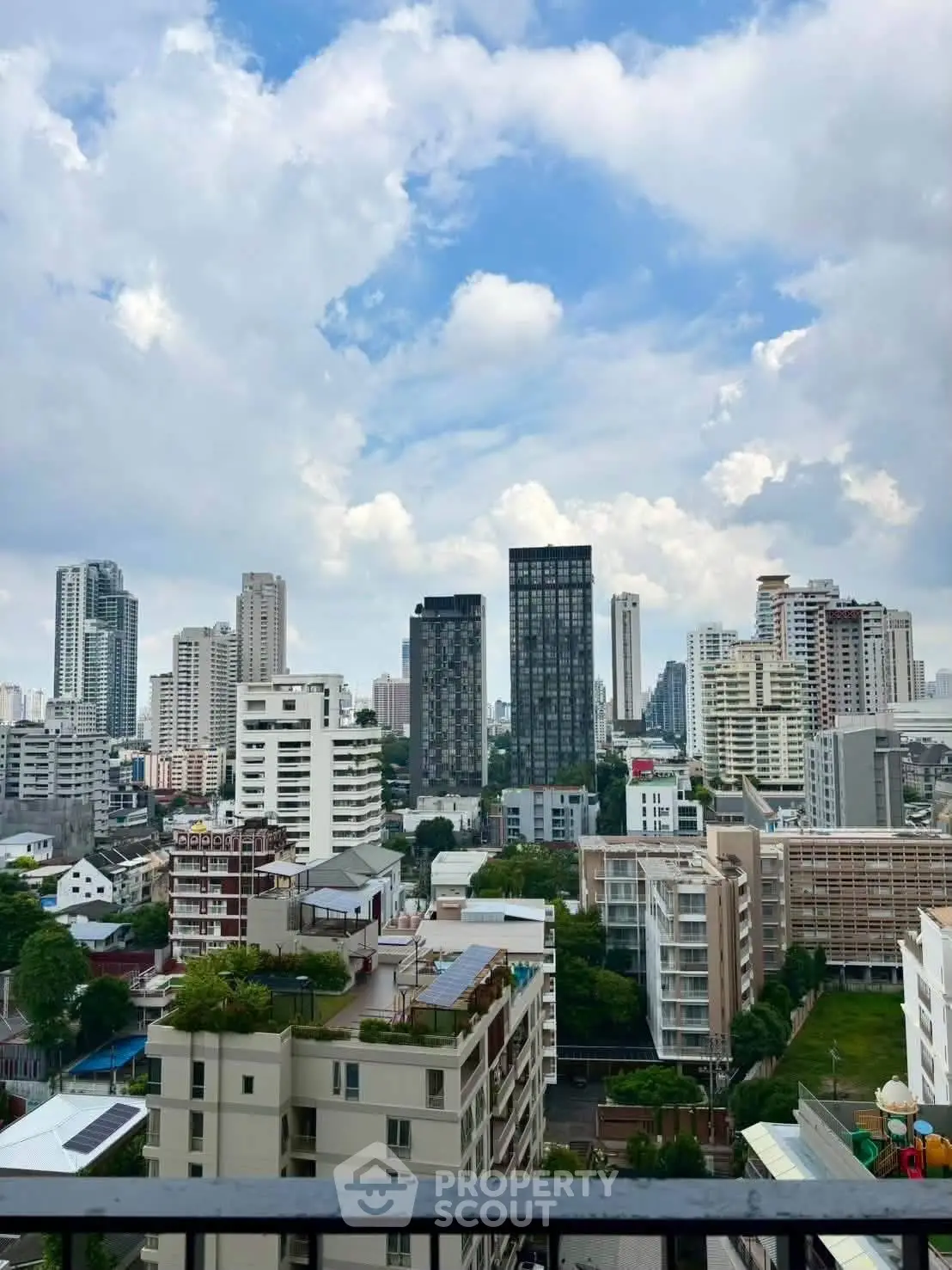 Stunning cityscape view from a high-rise balcony showcasing modern urban skyline.