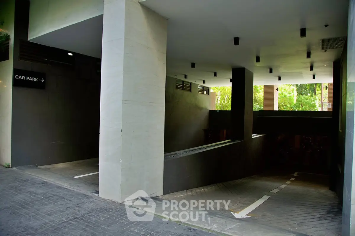 Modern underground parking entrance with sleek design and ample lighting.