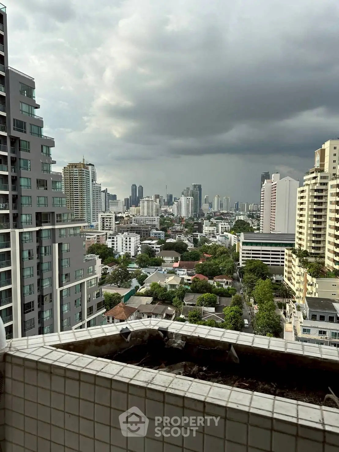 Stunning cityscape view from a high-rise balcony overlooking urban skyline.